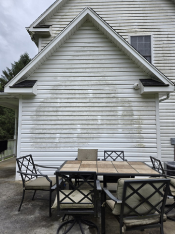 Residential home exterior with clean patio furniture and siding